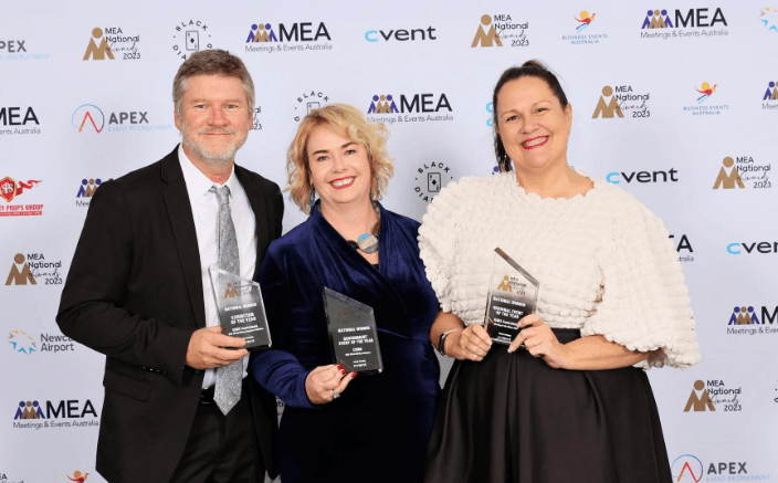 Three ICMSA team members holding trophies at the MEA National Awards